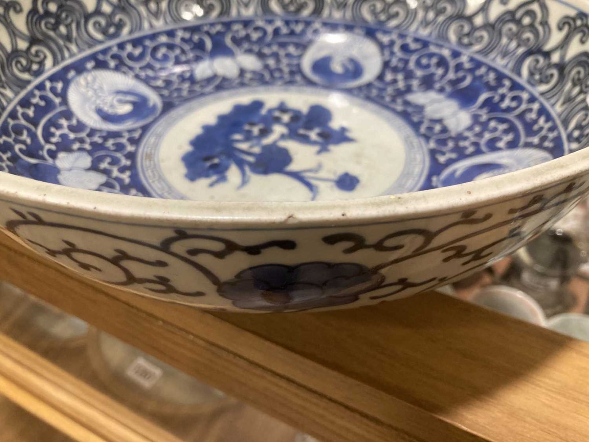 A Japanese blue and white bowl, centrally decorated with a shrubs within a scrolled border, - Image 8 of 12