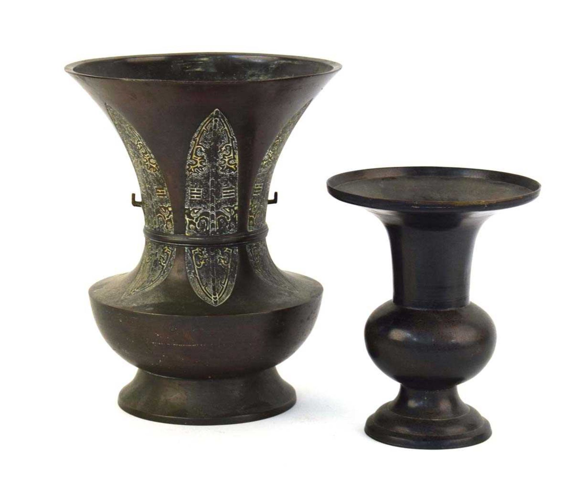 A 19th century Chinese brown patinated bronze vase of flared form, having six blade form sections
