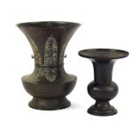 A 19th century Chinese brown patinated bronze vase of flared form, having six blade form sections