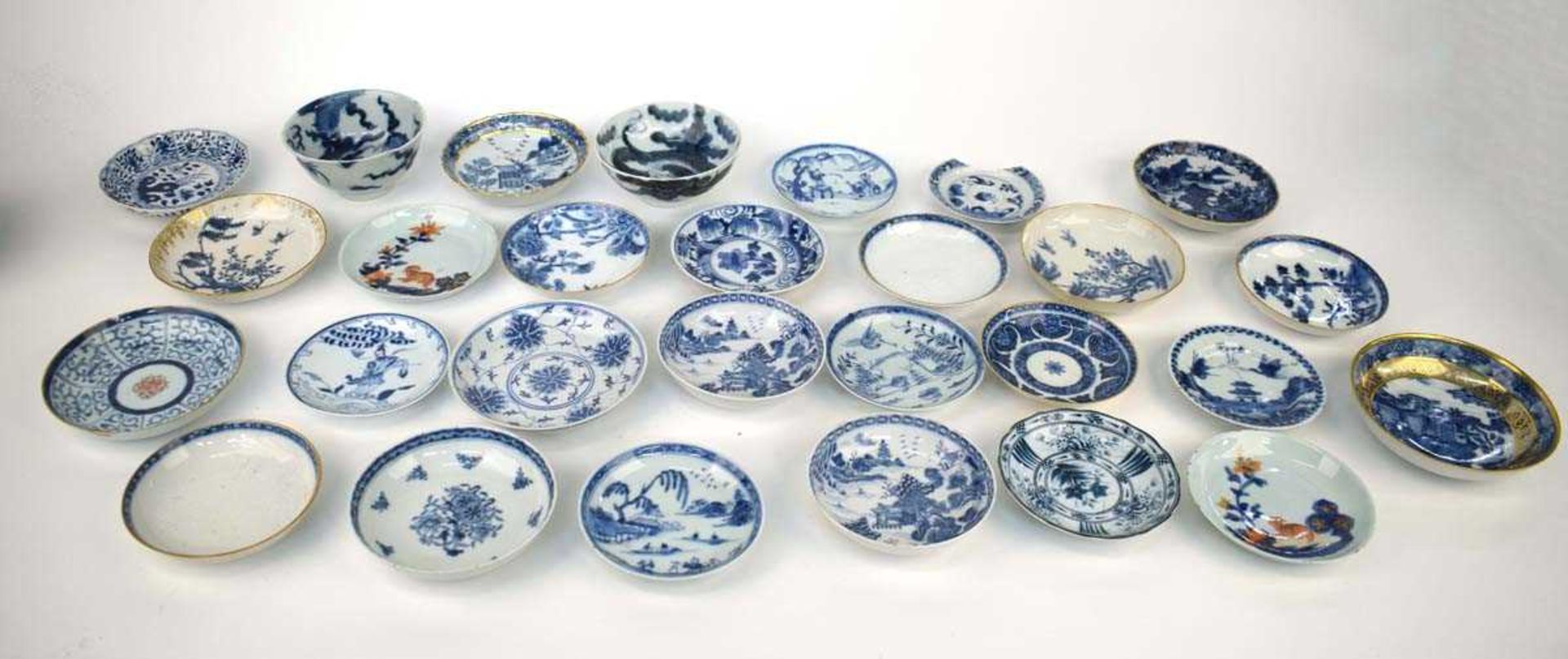 A large quantity of Chinese and other blue and white and imari decorated tea bowls, tea cups,