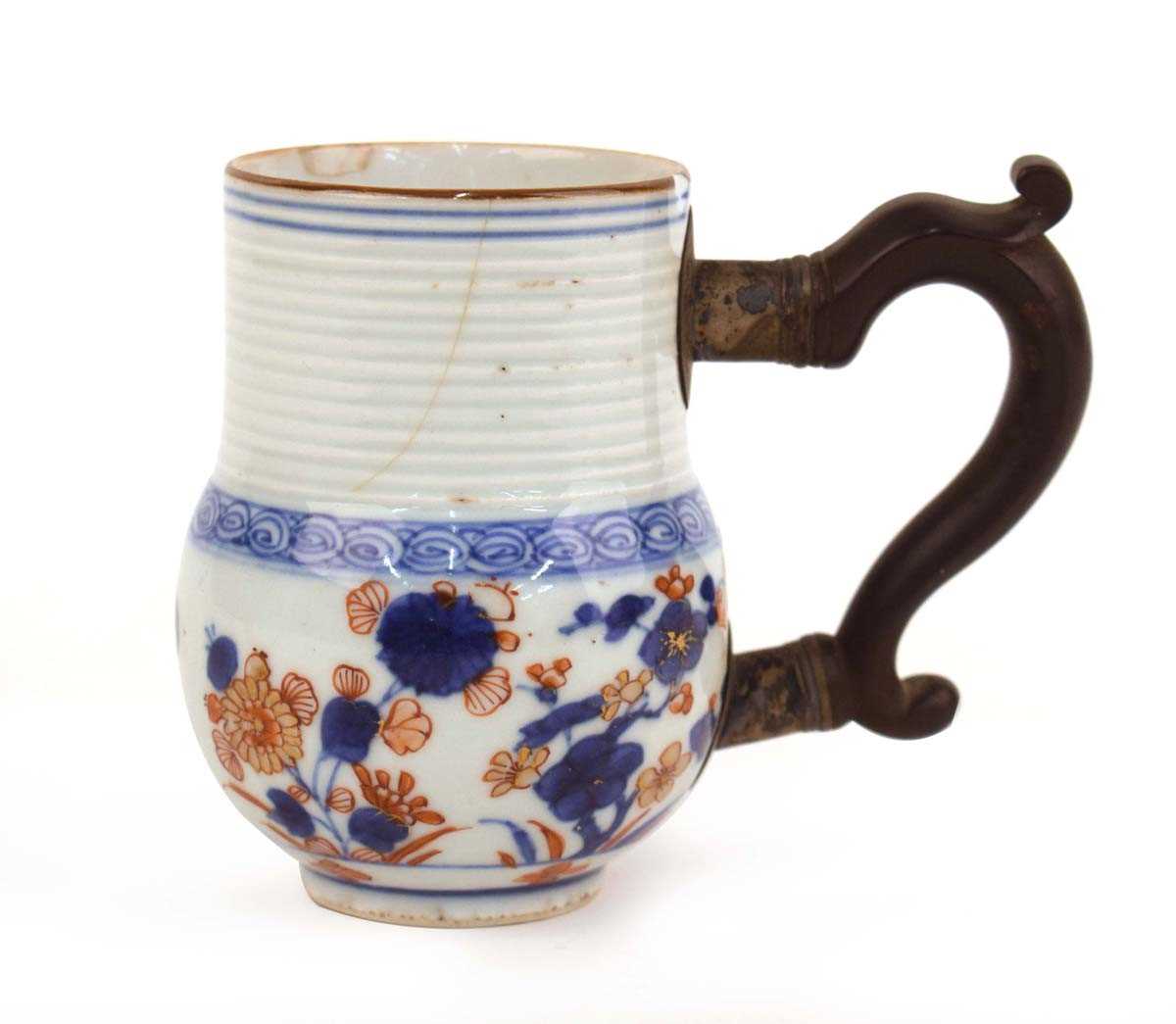A Chinese mug of typical form with horizontal ribbing decorated in the Imari palette, later