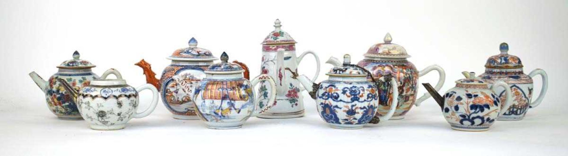 A Chinese famille rouge teapot and cover of globular form, typically decorated with traditional