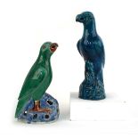 A Chinese figure modelled as a seated parrot, decorated in a plain kingfisher blue glaze, h. 25