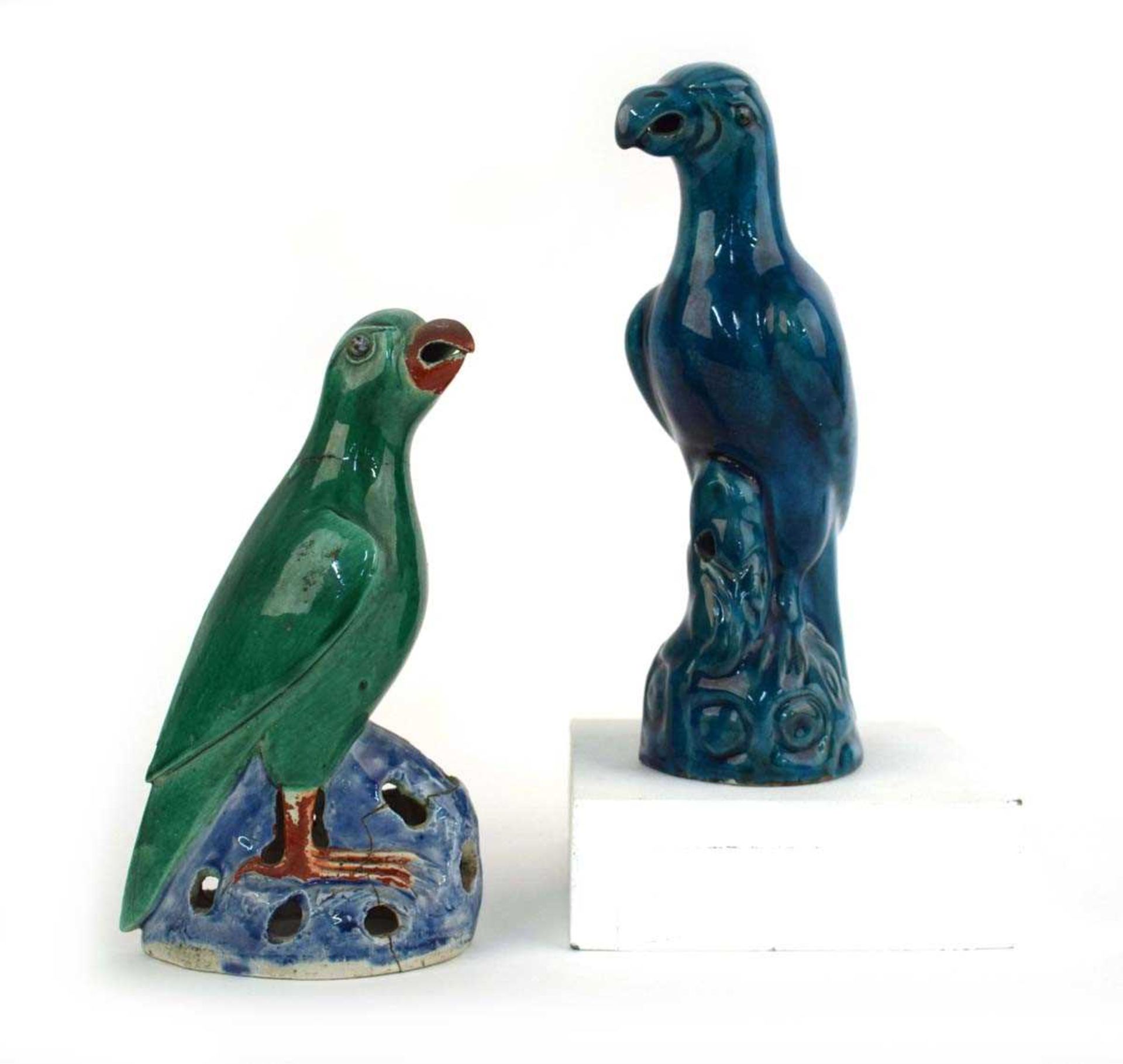 A Chinese figure modelled as a seated parrot, decorated in a plain kingfisher blue glaze, h. 25