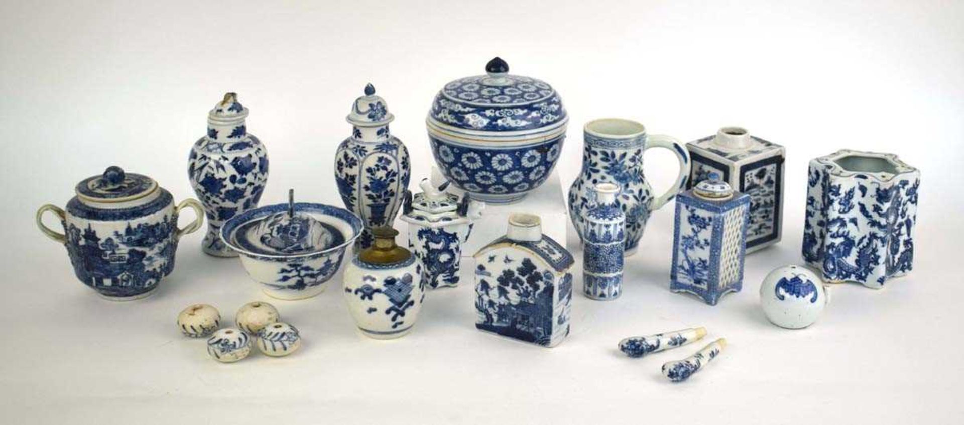 A mixed group of Chinese and other blue and white ceramics including beads, lidded vases, caddies