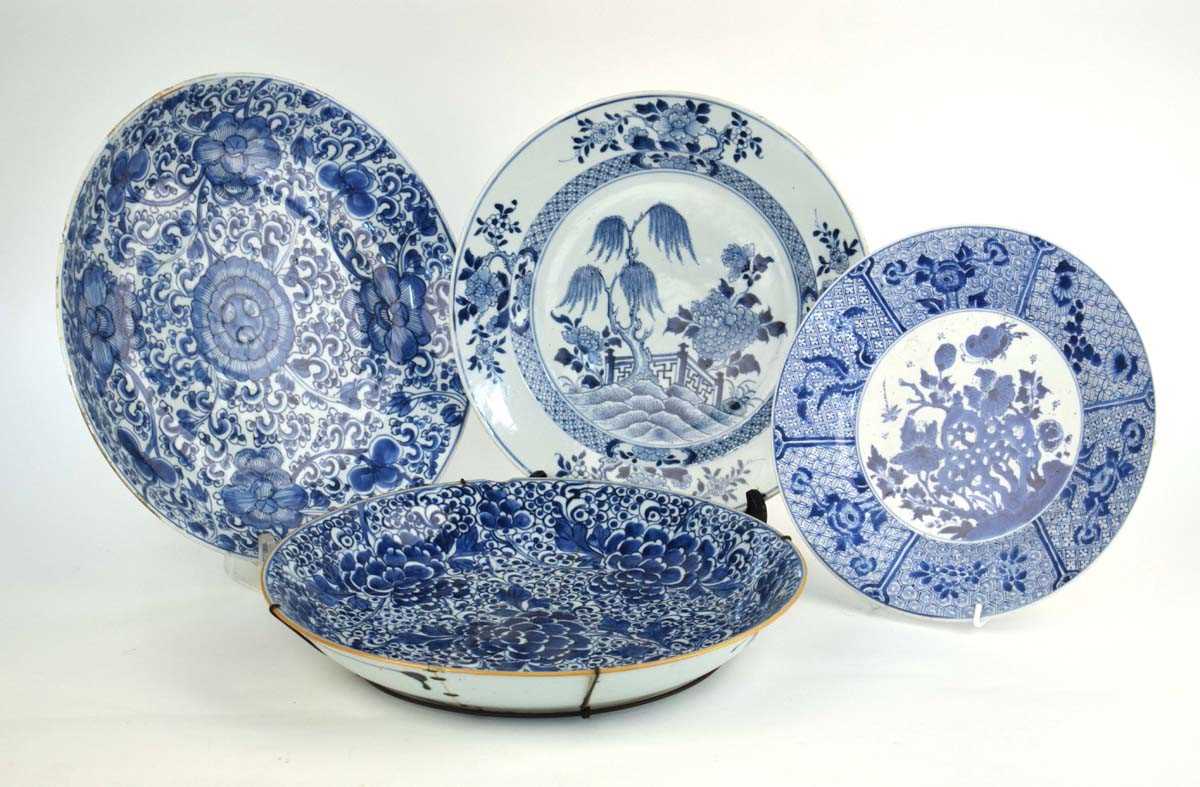 A Chinese blue and white charger centrally decorated with a weeping willow amongst a foliate