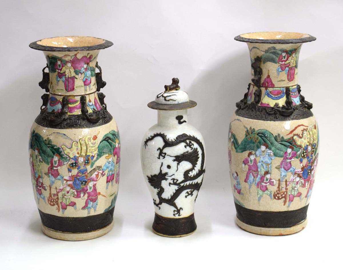 A pair of Chinese baluster vases, each decorated in coloured enamels with a processional scene on