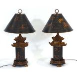 A pair of late 20th century chinoiserie table lamps, the black shades with gilded relief detail over