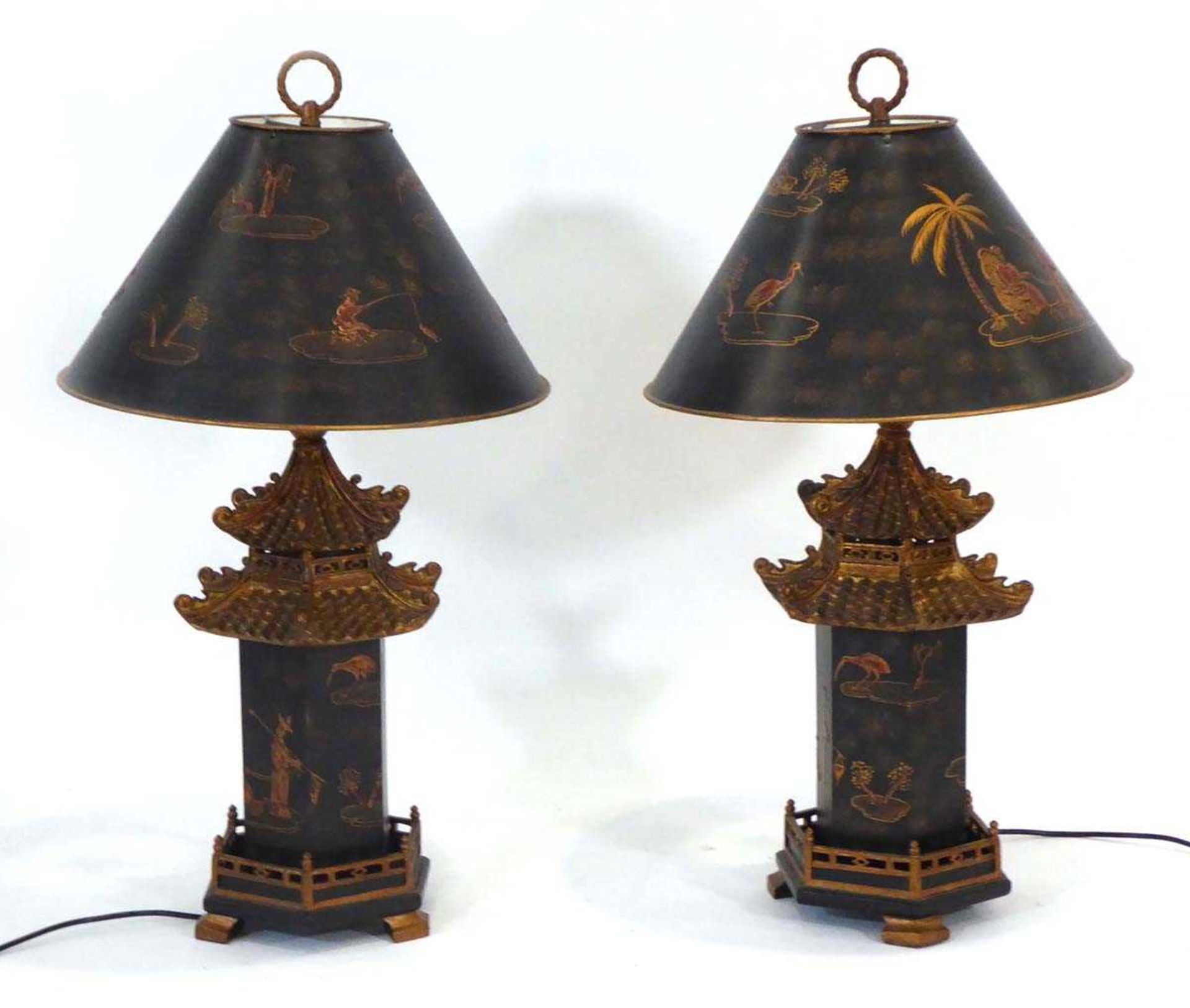 A pair of late 20th century chinoiserie table lamps, the black shades with gilded relief detail over