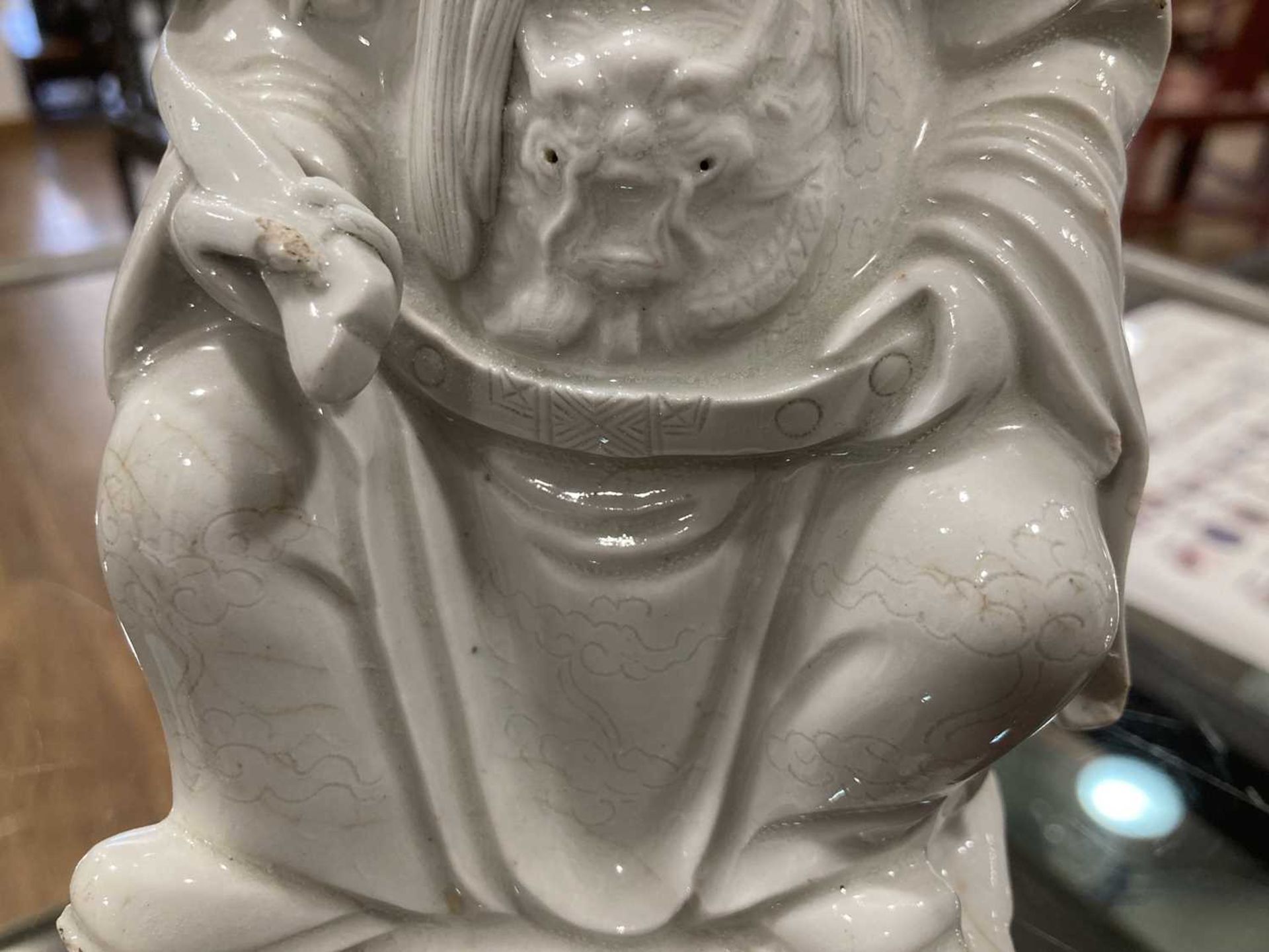 A Chinese blanc de chine figure, possibly Dong Fangshuo, holding a walking stick on a swirl design - Image 15 of 22