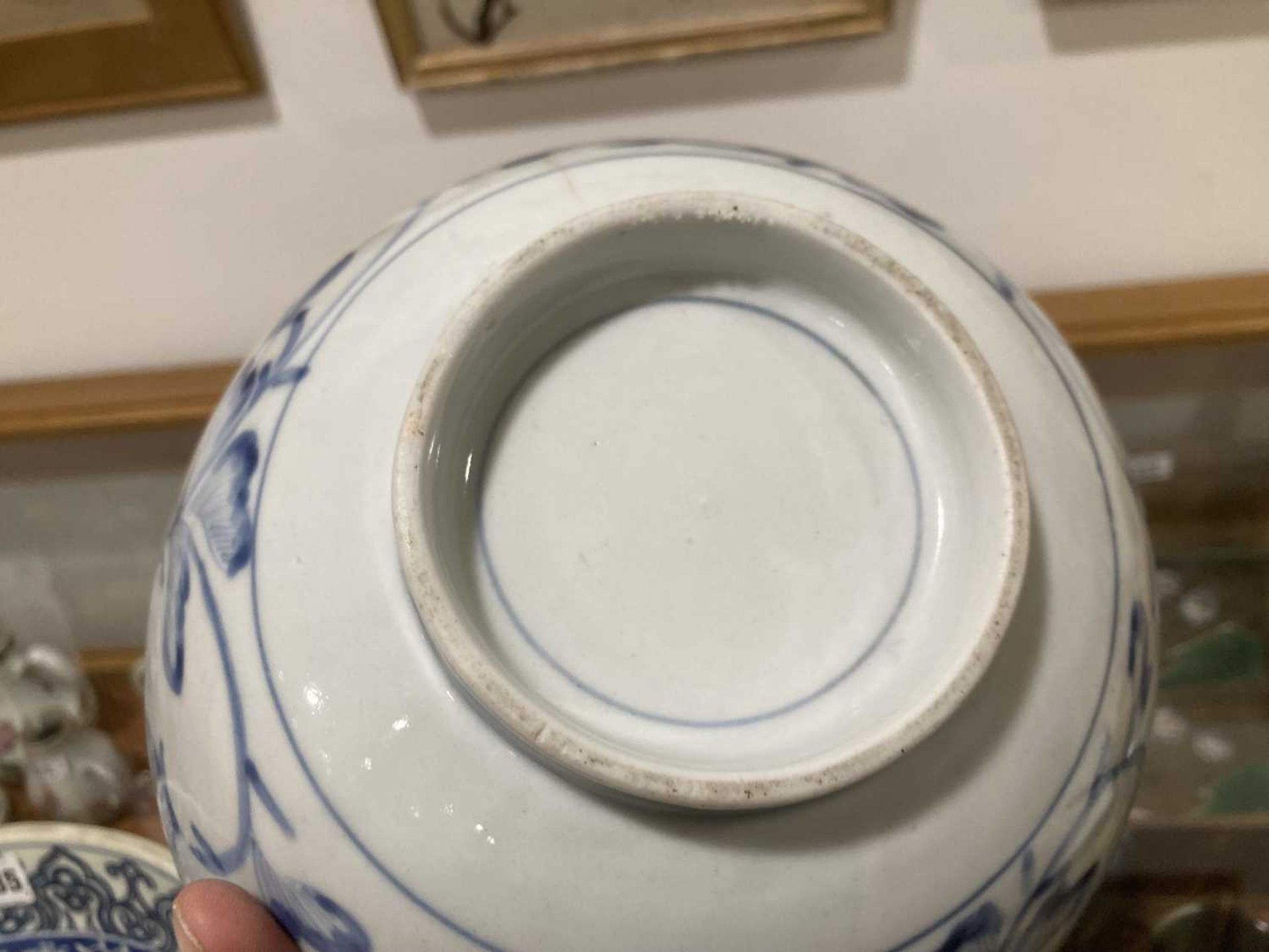 A Japanese blue and white bowl, centrally decorated with a shrubs within a scrolled border, - Image 6 of 12