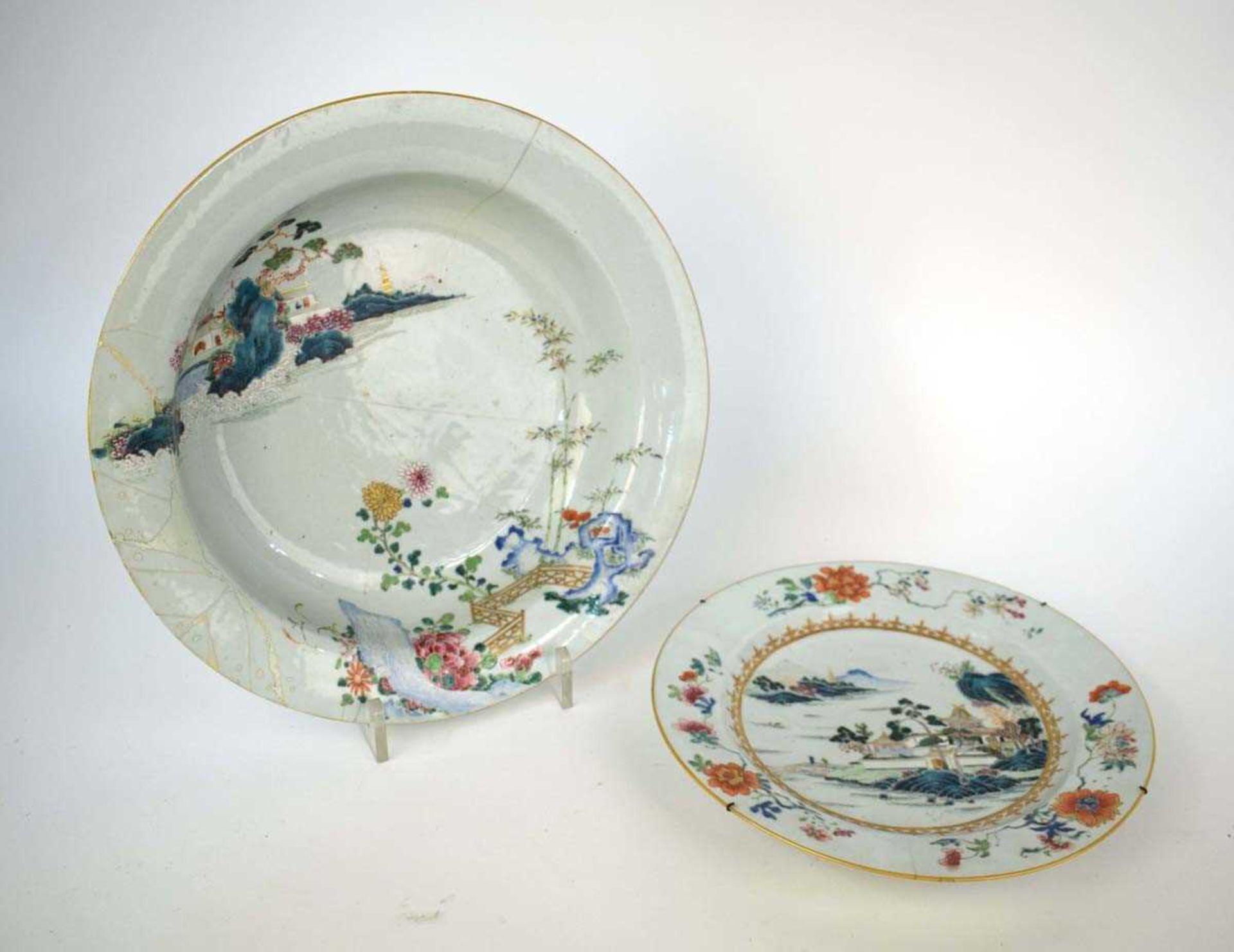 A Chinese charger decorated in coloured enamels with an extensive landscape within a foliate border,