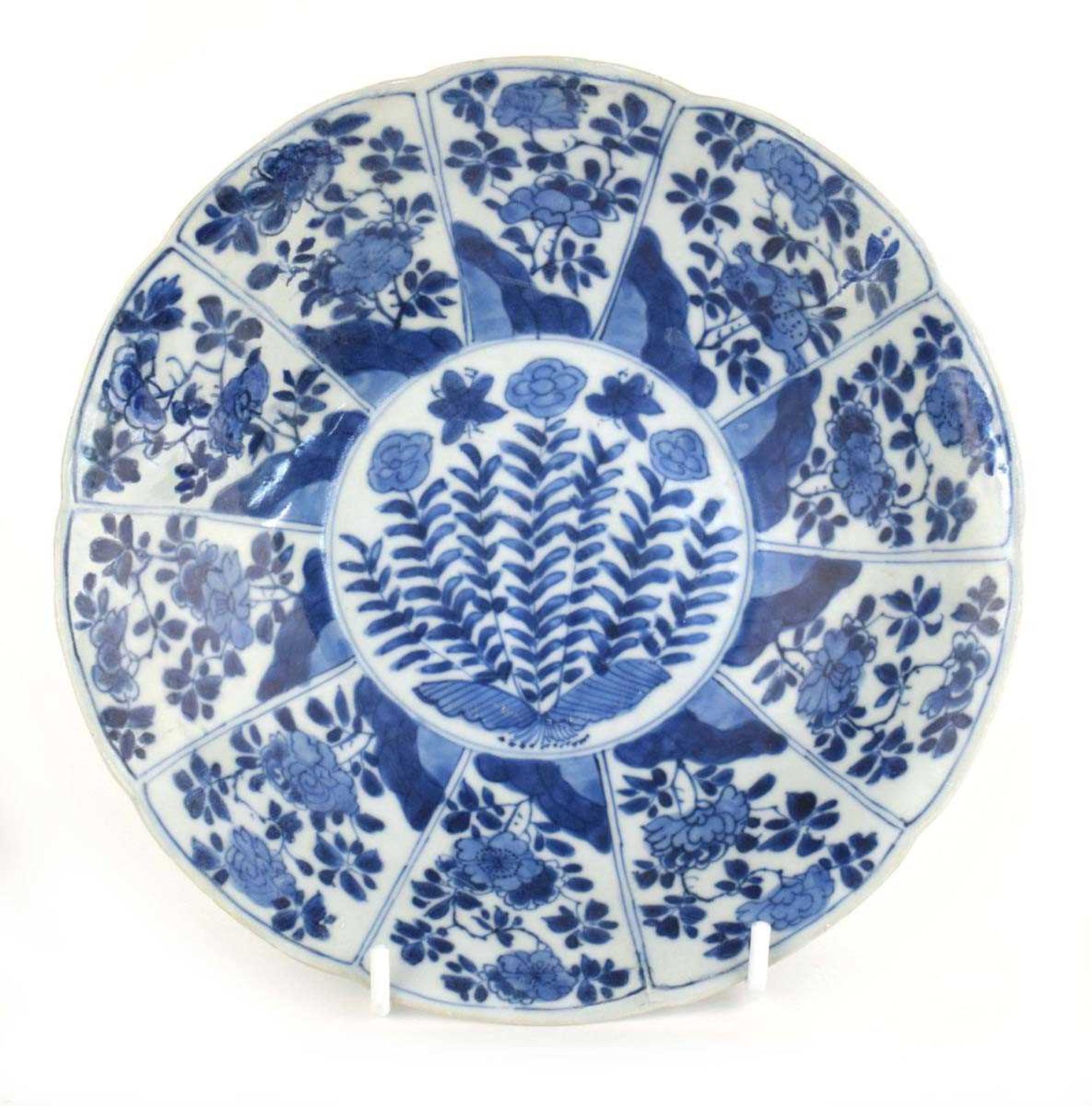 A Chinese blue and white shallow dish of flowerhead form, decorated with floral blooms within ten
