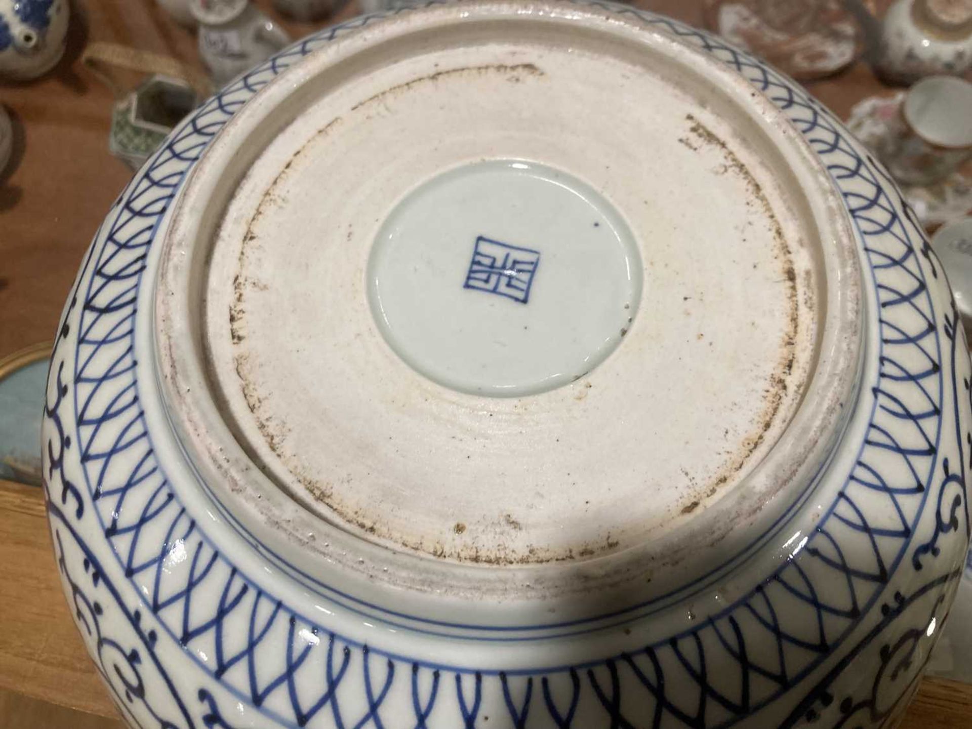 A Japanese blue and white bowl, centrally decorated with a shrubs within a scrolled border, - Image 9 of 12