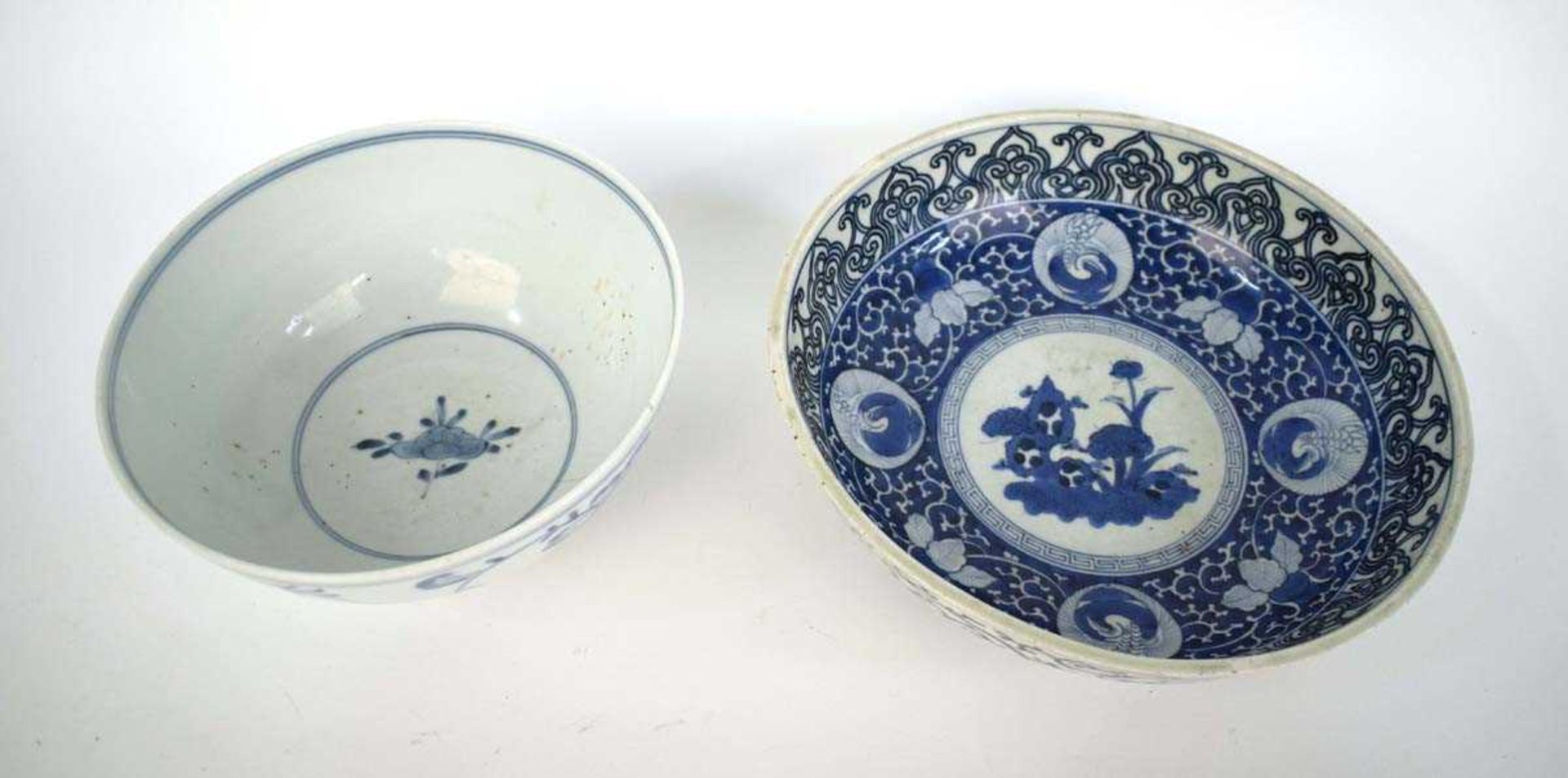 A Japanese blue and white bowl, centrally decorated with a shrubs within a scrolled border, - Image 2 of 12