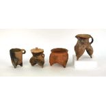 A Chinese archaic pottery jug of tripod form, h. 16 cm, together with three similar vessels (4) *