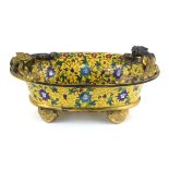 A 19th century Chinese cloisonné jardinière of oval form, decorated with floral motifs within a