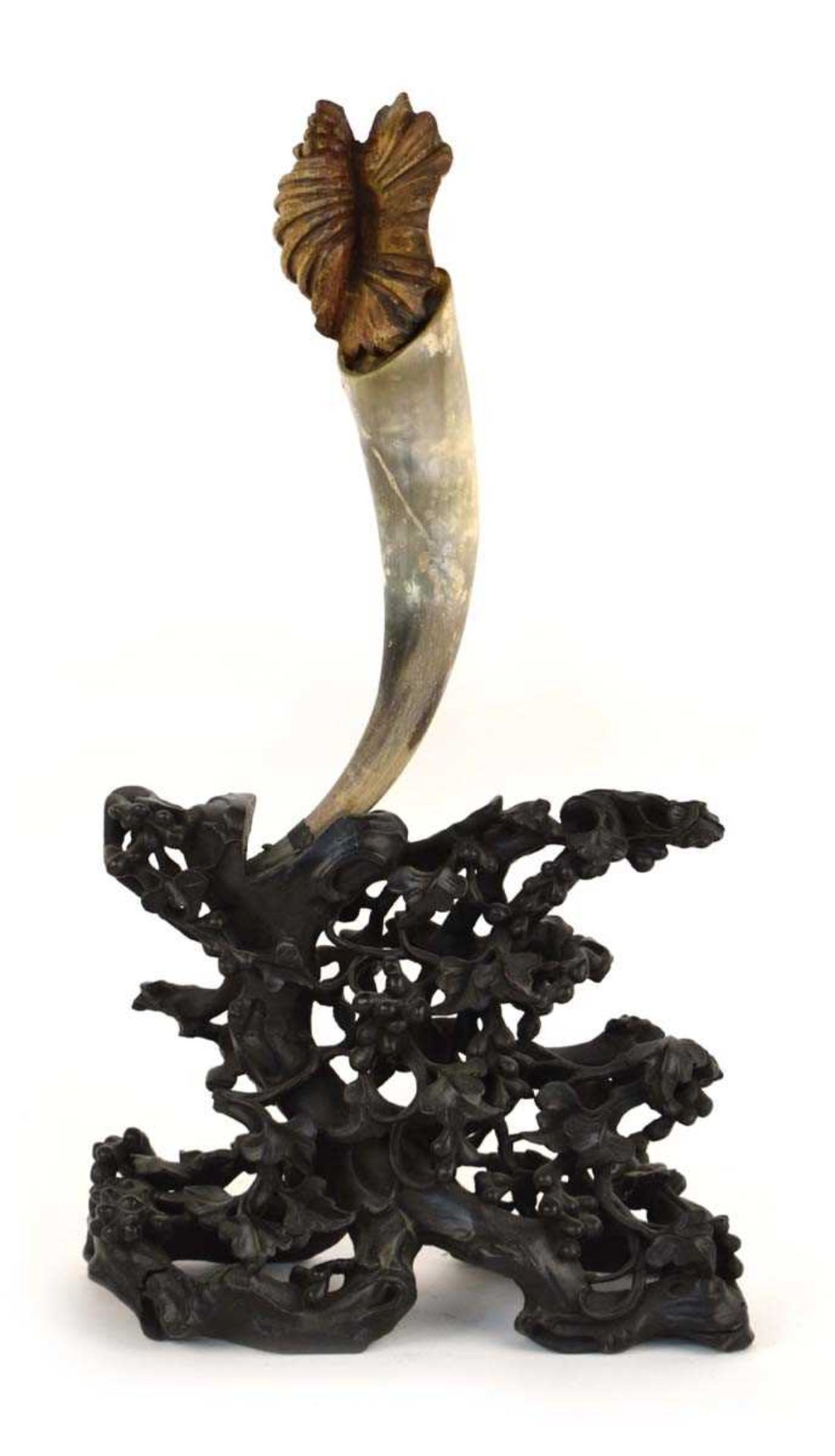 A Chinese carved hardwood stand modelled as stylised leaves supporting a horn, h. 69.5 cm *from