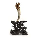 A Chinese carved hardwood stand modelled as stylised leaves supporting a horn, h. 69.5 cm *from