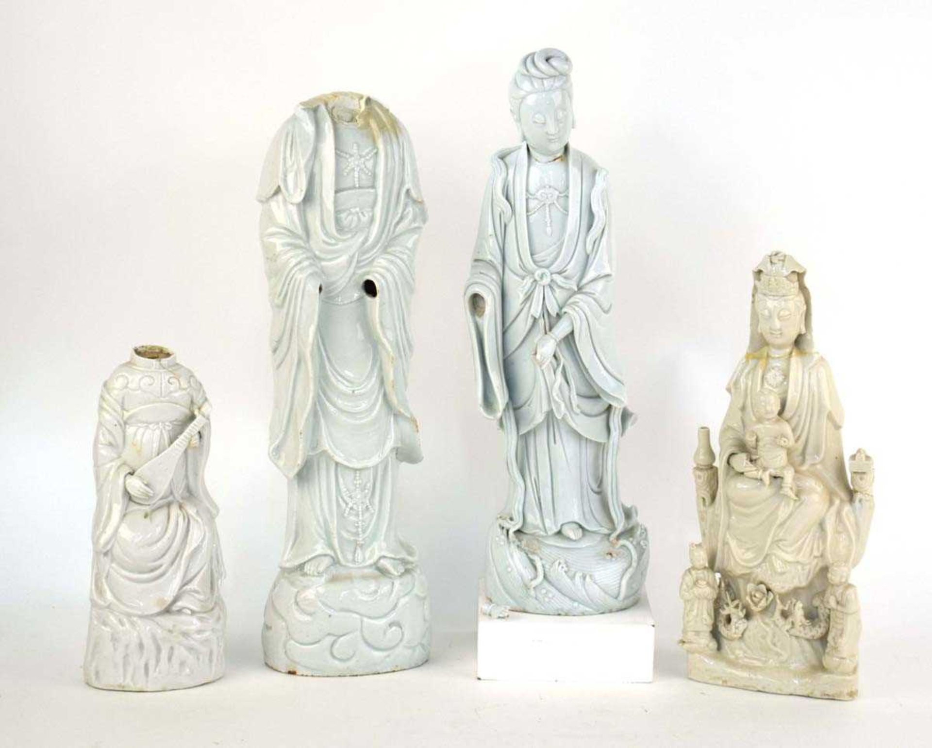 A large scale Chinese blanc de chine figure modelled as Guanyin on a naturalistic base, h. 49 cm, w.