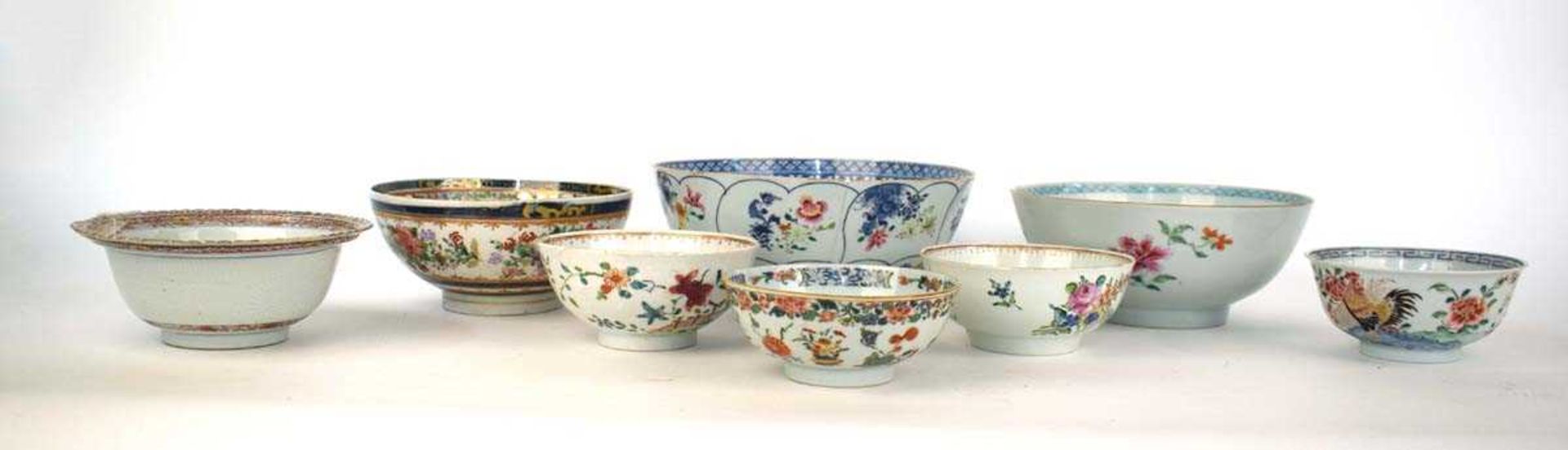 A Chinese bowl externally decorated in coloured enamels with spring and summer flowers within a blue