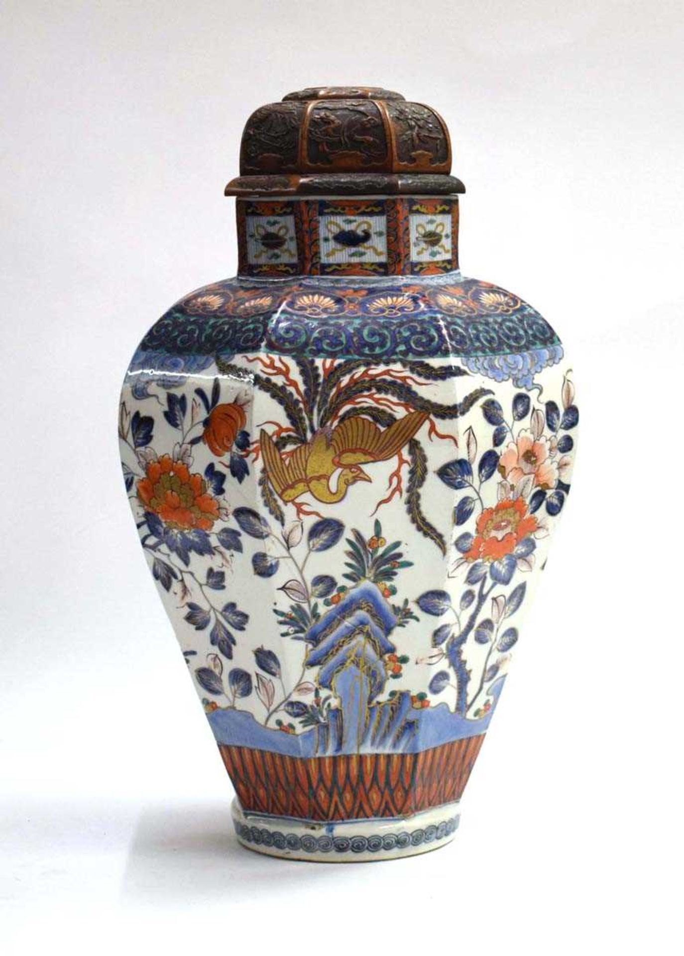 A Chinese covered jar of shouldered octagonal form decorated in the imari palette with exotic