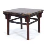 A Chinese red lacquered occasional table of square form, on circular legs joined by stretchers, 68 x