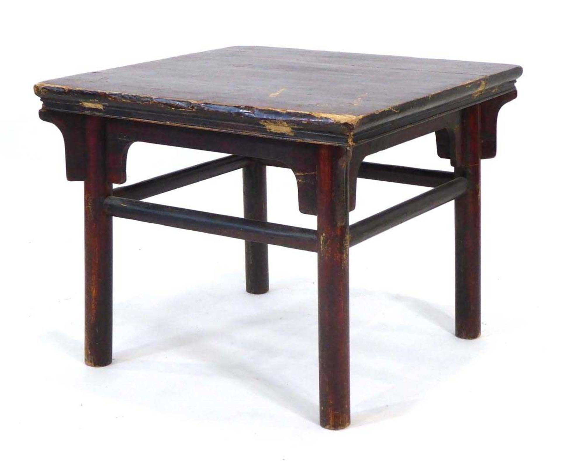 A Chinese red lacquered occasional table of square form, on circular legs joined by stretchers, 68 x