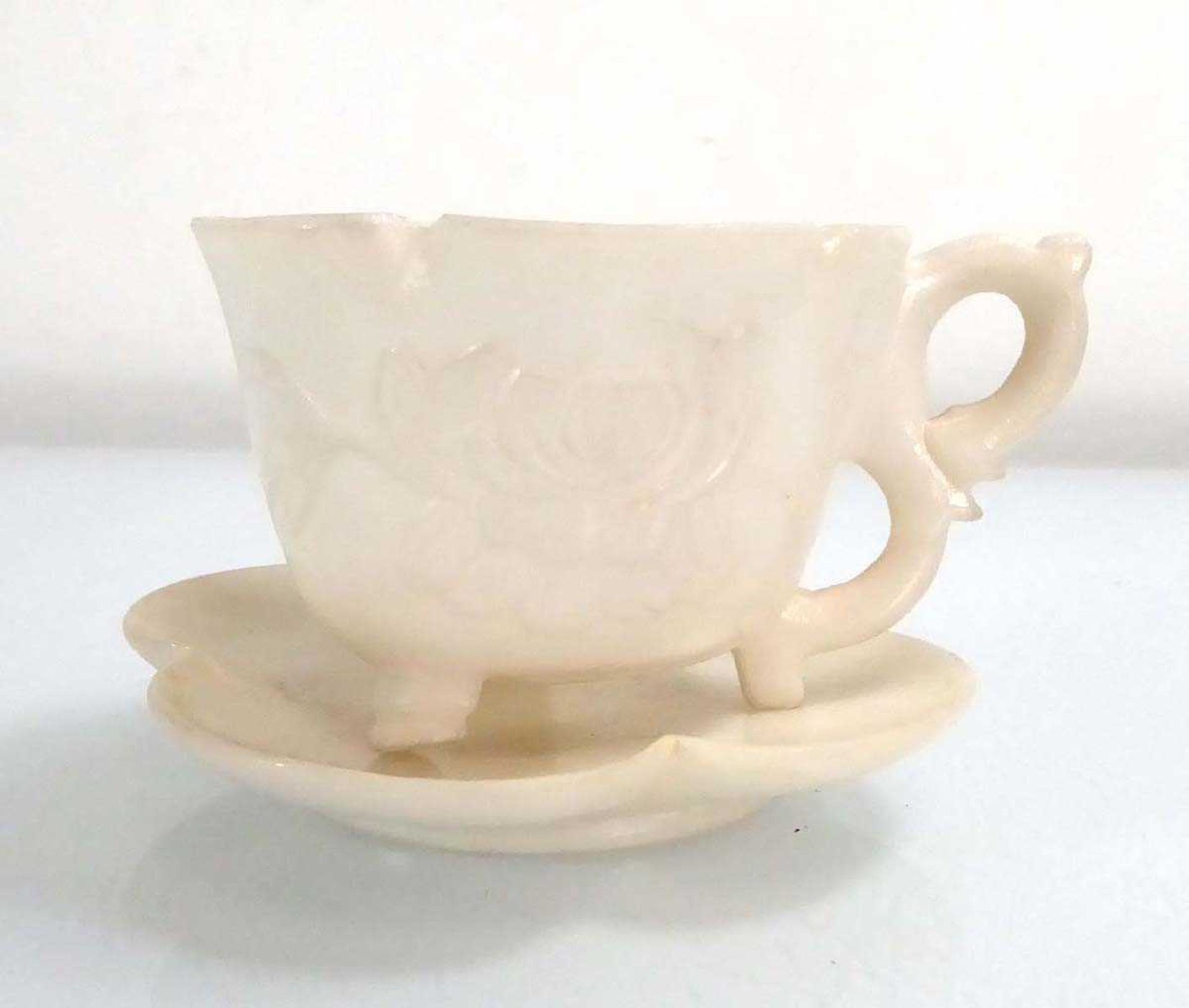 A Chinese carved white stone tea cup and saucer of lotus flower design, cup h. 4.5 cm (2) *from