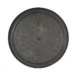 A Chinese Export cast metal 'mirror', relief decorated with figures and characters, d. 40.5 cm,