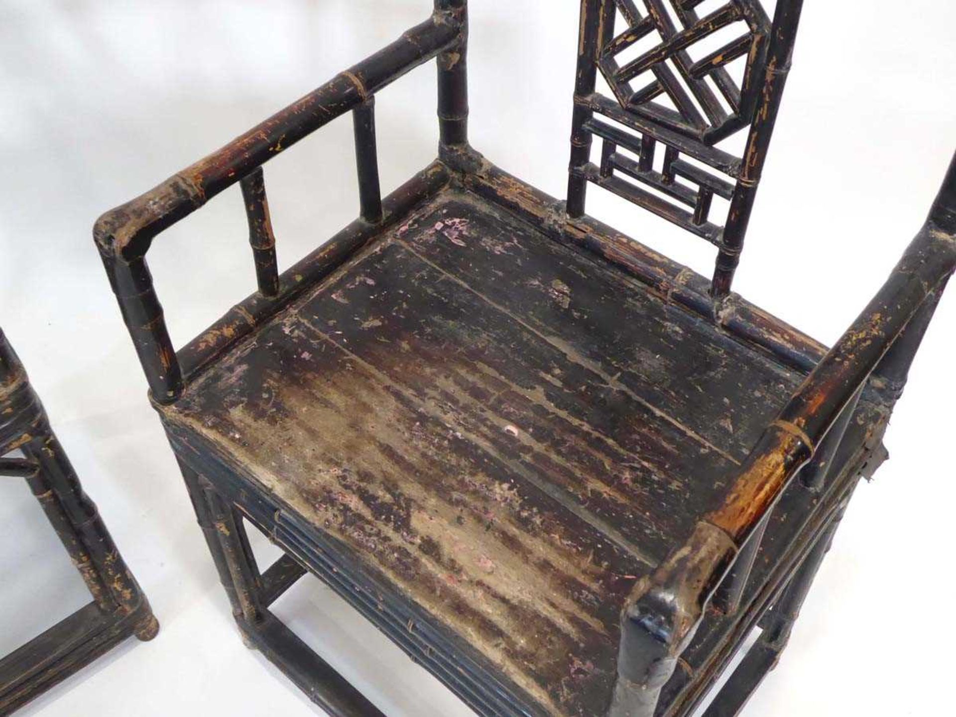 A pair of Chinese bamboo and lacquered elbow chairs with decorative trellis splats, solid seats - Image 2 of 2