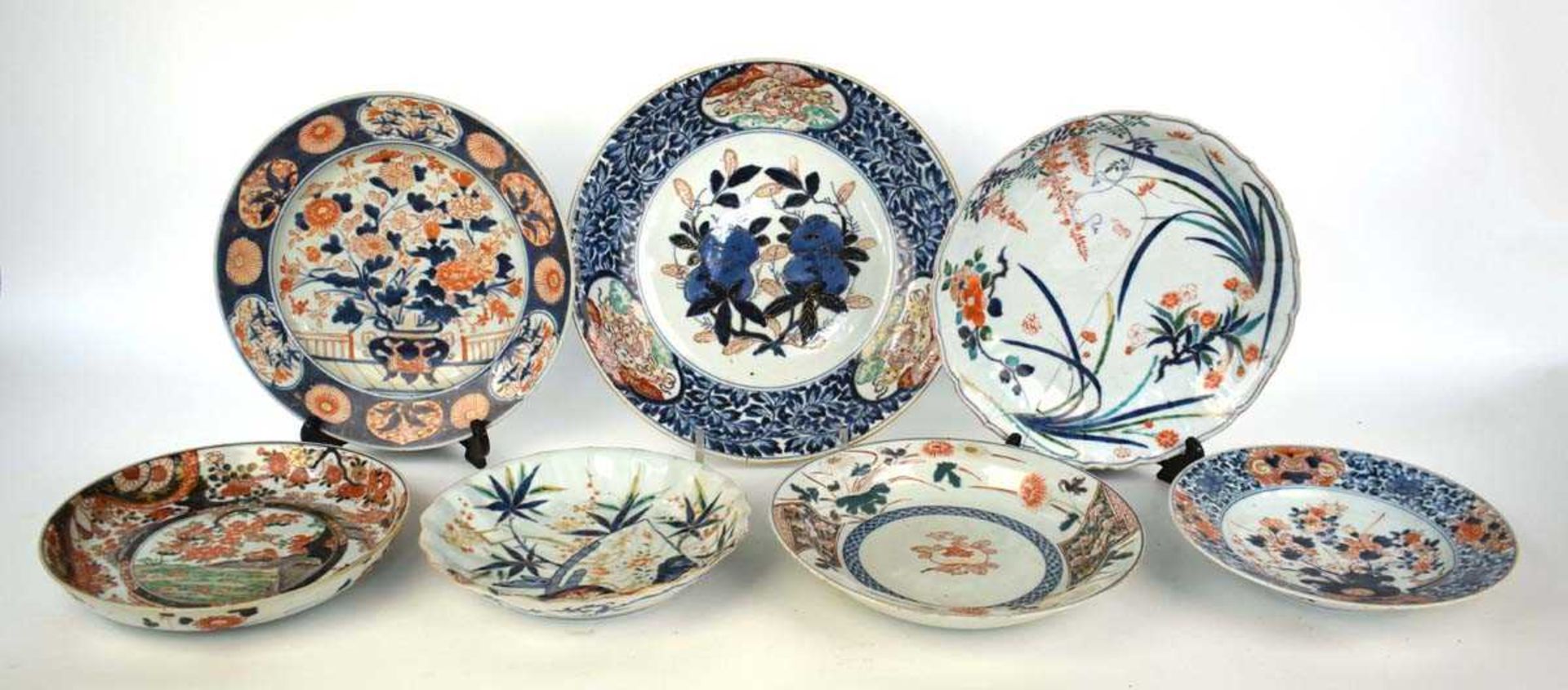 A Japanese charger centrally decorated with persimmon in the imari palette, within a mythical