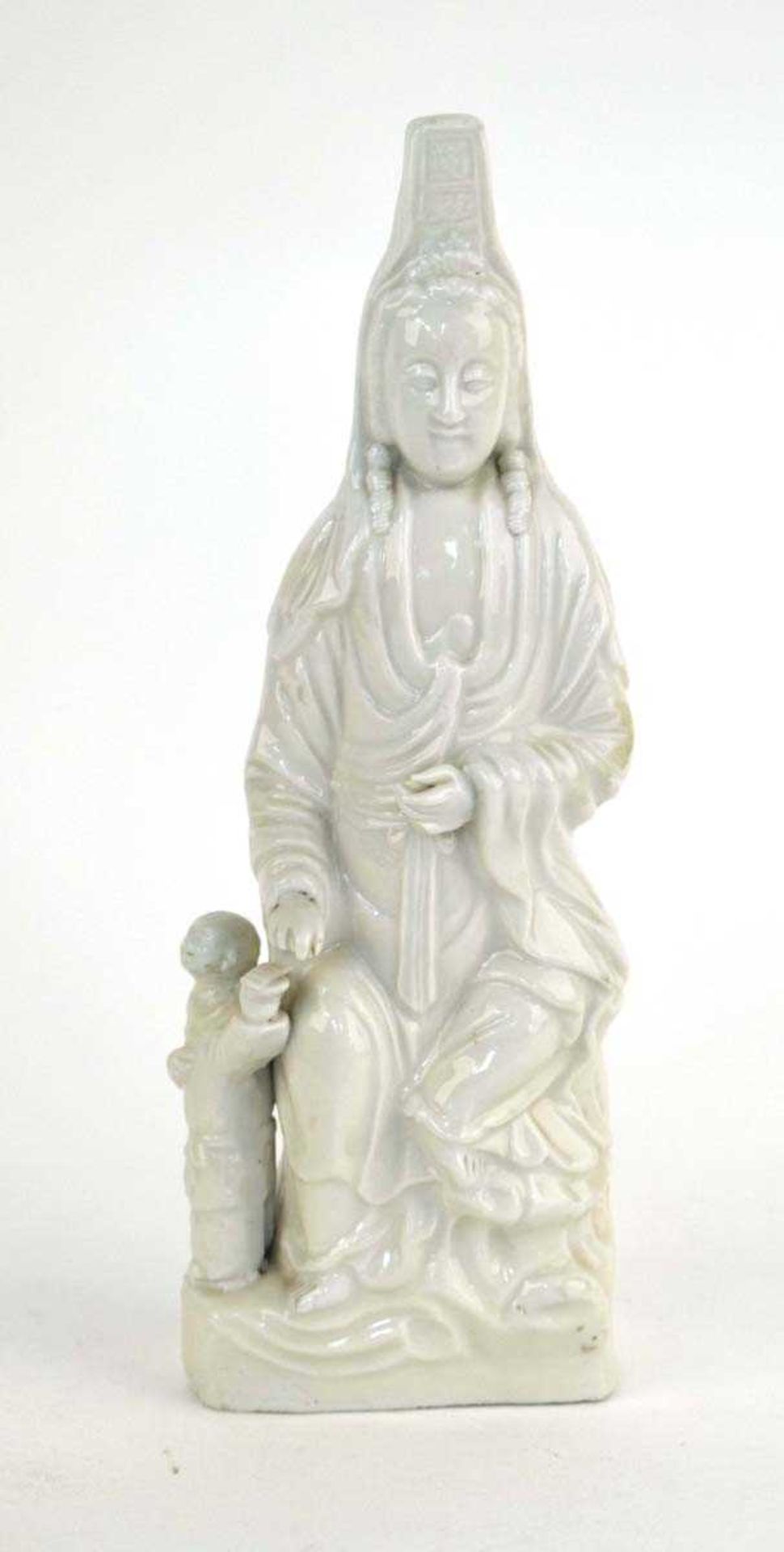 A Chinese blanc de chine figure modelled as Guanyin and her infant companion, h. 32 cm, w. 11 cm, d.