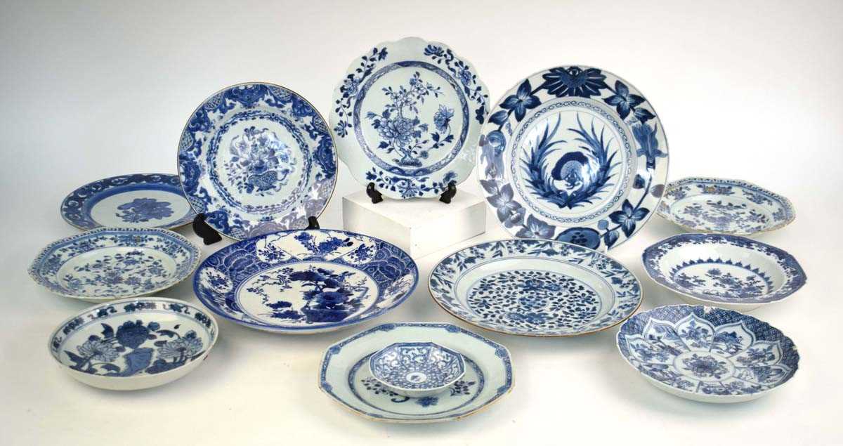 A Chinese blue and white side plate of scalloped form, centrally decorated with flowers in full