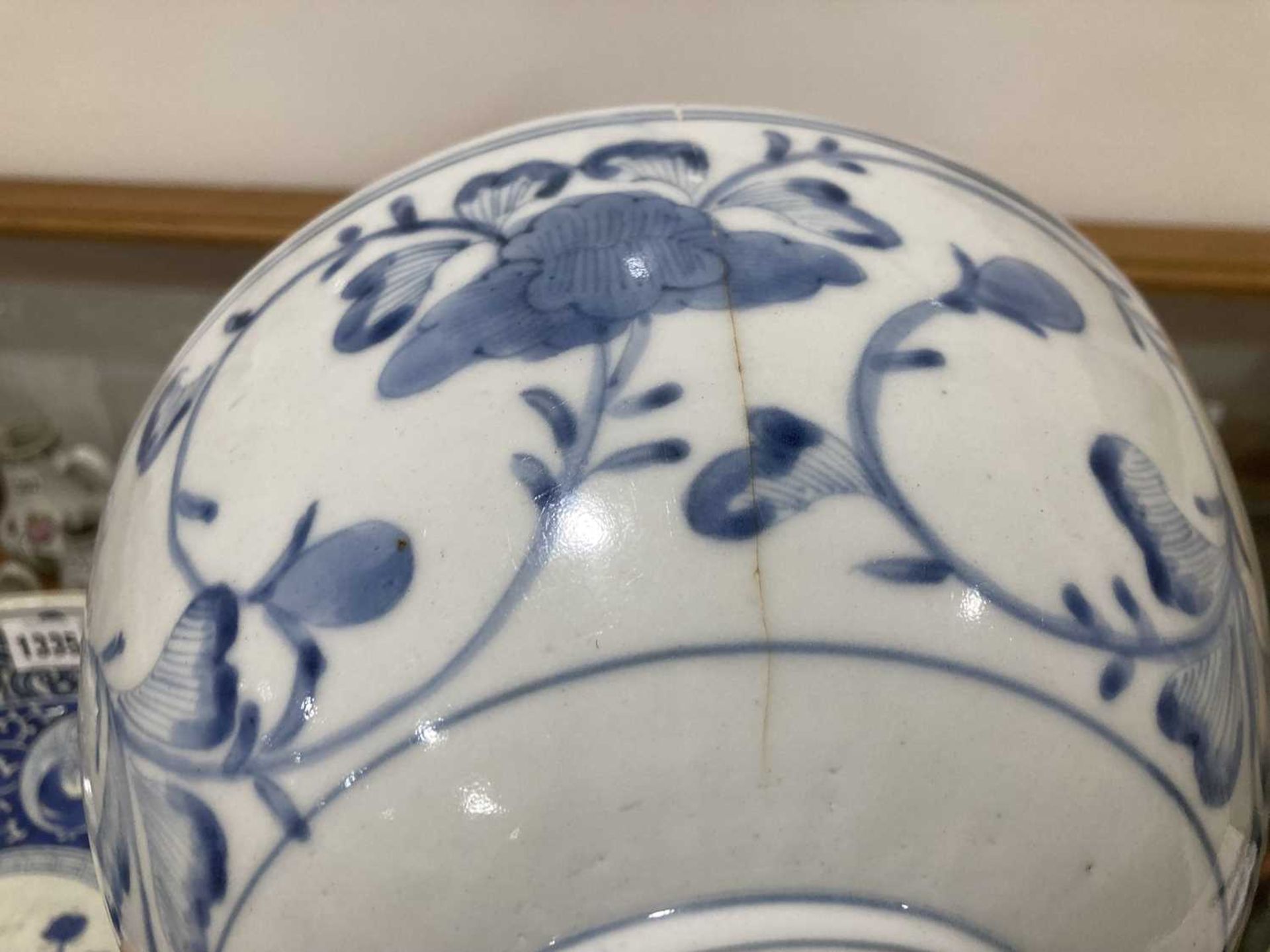 A Japanese blue and white bowl, centrally decorated with a shrubs within a scrolled border, - Bild 7 aus 12