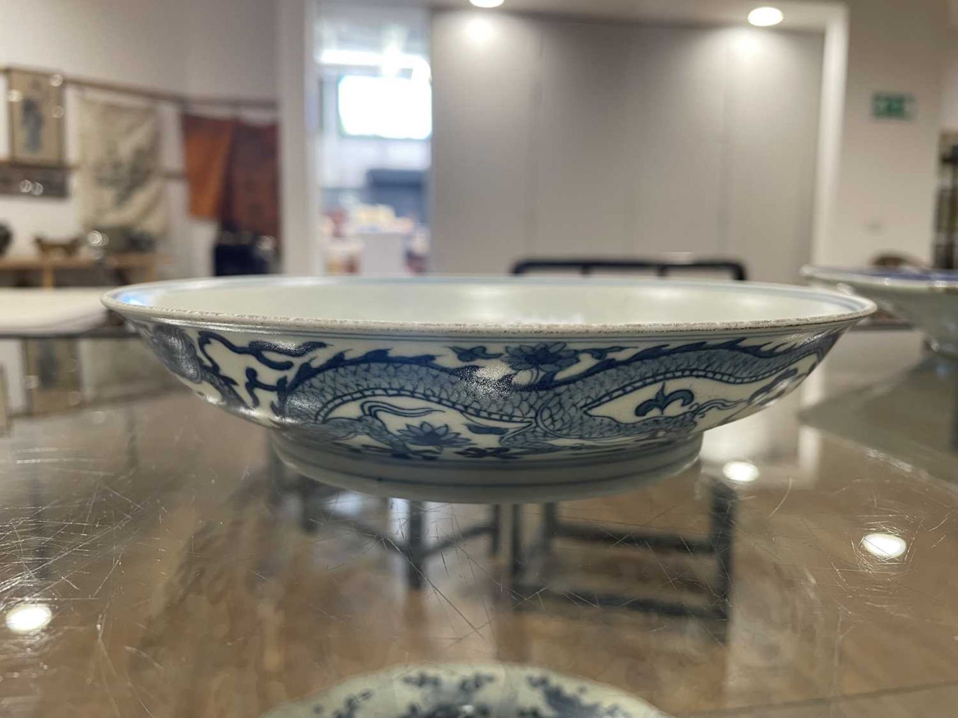 A Chinese blue and white shallow dish, centrally decorated with a dragon and lotus flowers, pseudo - Image 20 of 31