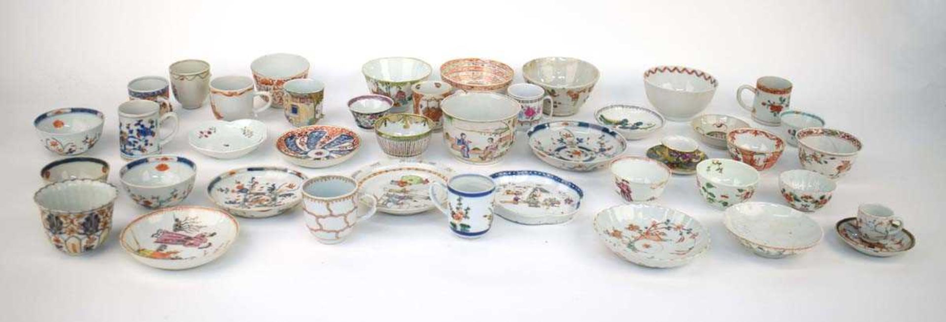 A large quantity of Chinese and other enamel and imari decorated tea bowls, tea cups, saucers and