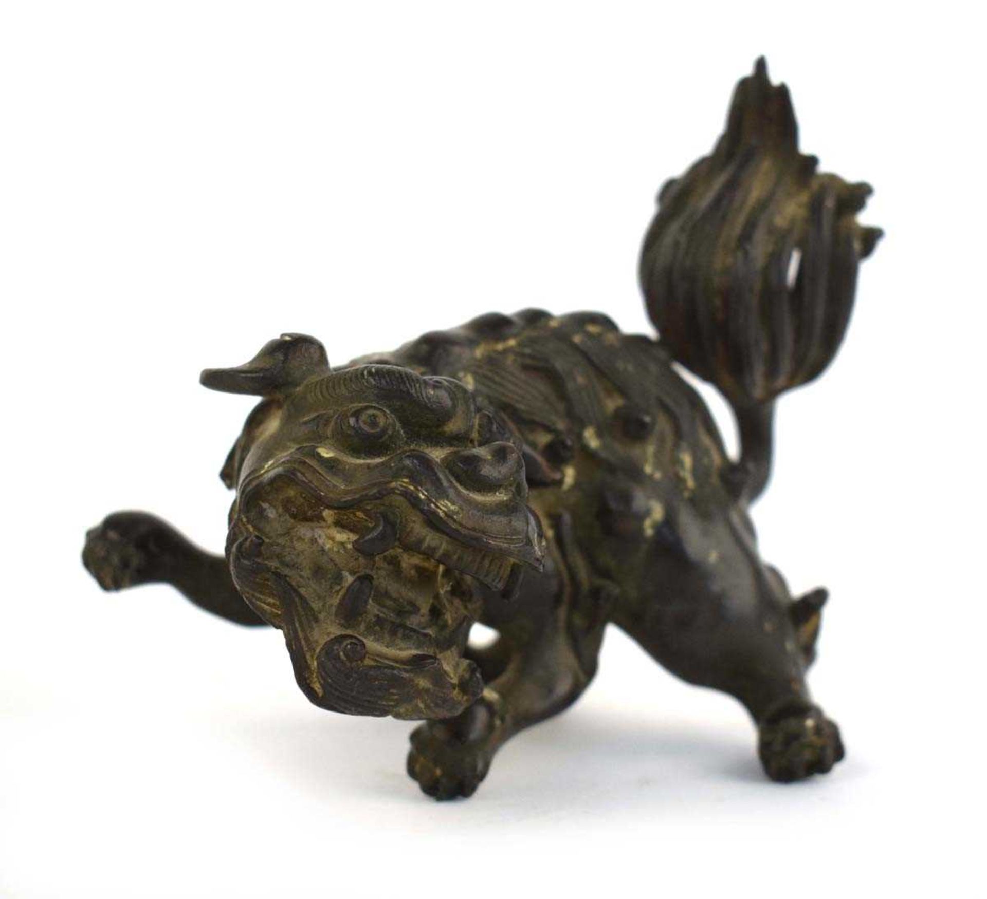 A Chinese brown patinated bronze figure modelled as a foo dog, h. 10.5 cm, d. 8.5 cm, 730 gms *