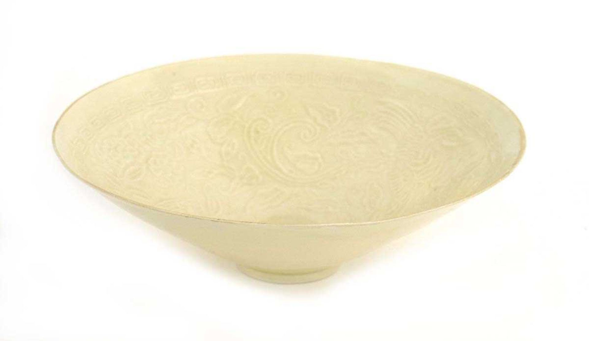 A Chinese celadon bowl of flared circular form, relief decorated with ho ho birds within a key