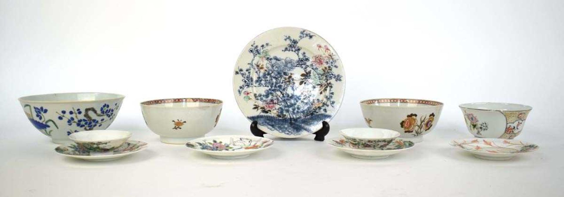 A group of Japanese eggshell porcelain including five saucers, each decorated in coloured enamels