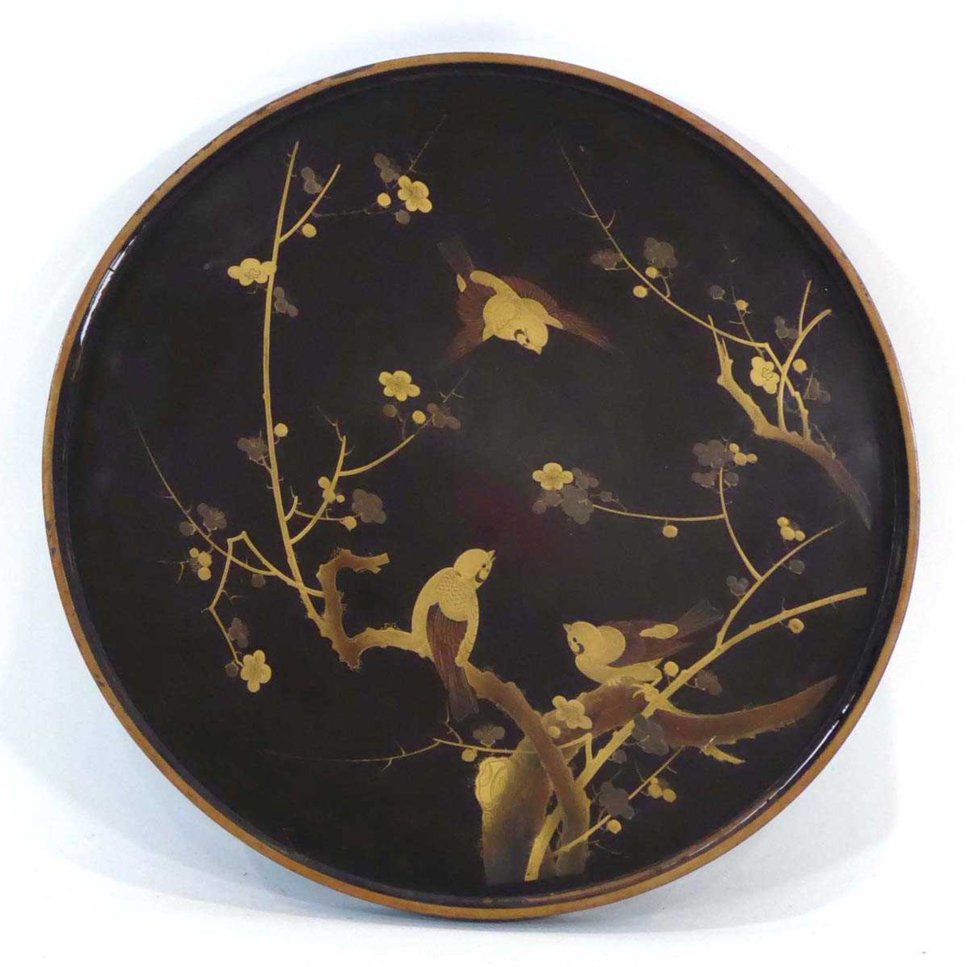 A Japanese circular black lacquered tray relief decorated with gilt birds on branches, di. 60 cm *