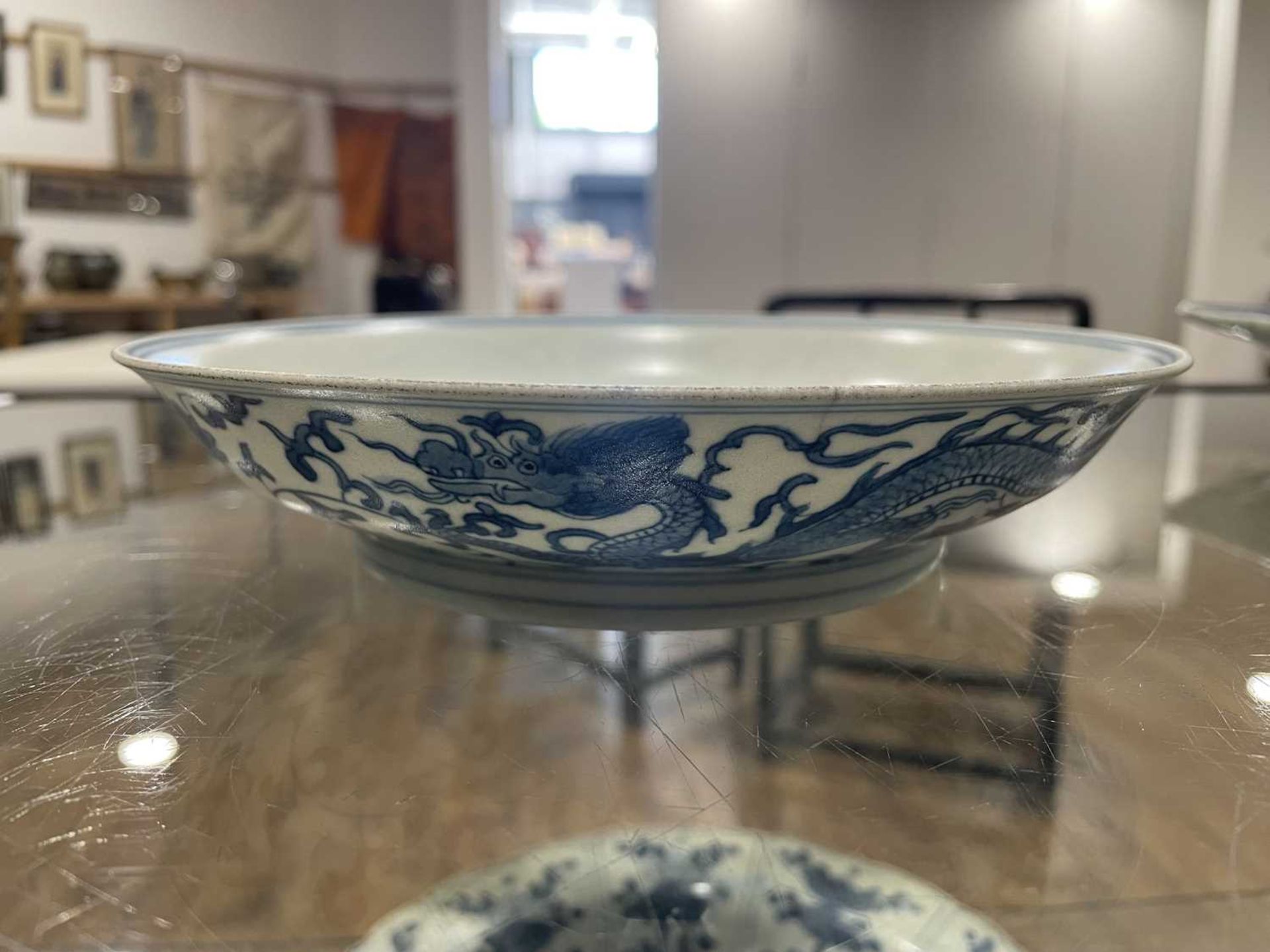 A Chinese blue and white shallow dish, centrally decorated with a dragon and lotus flowers, pseudo - Image 31 of 31