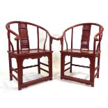 A pair of Chinese red painted Ming-style armchairs of cow horn form, w. 67 cm, h. 101 cm, d. 61