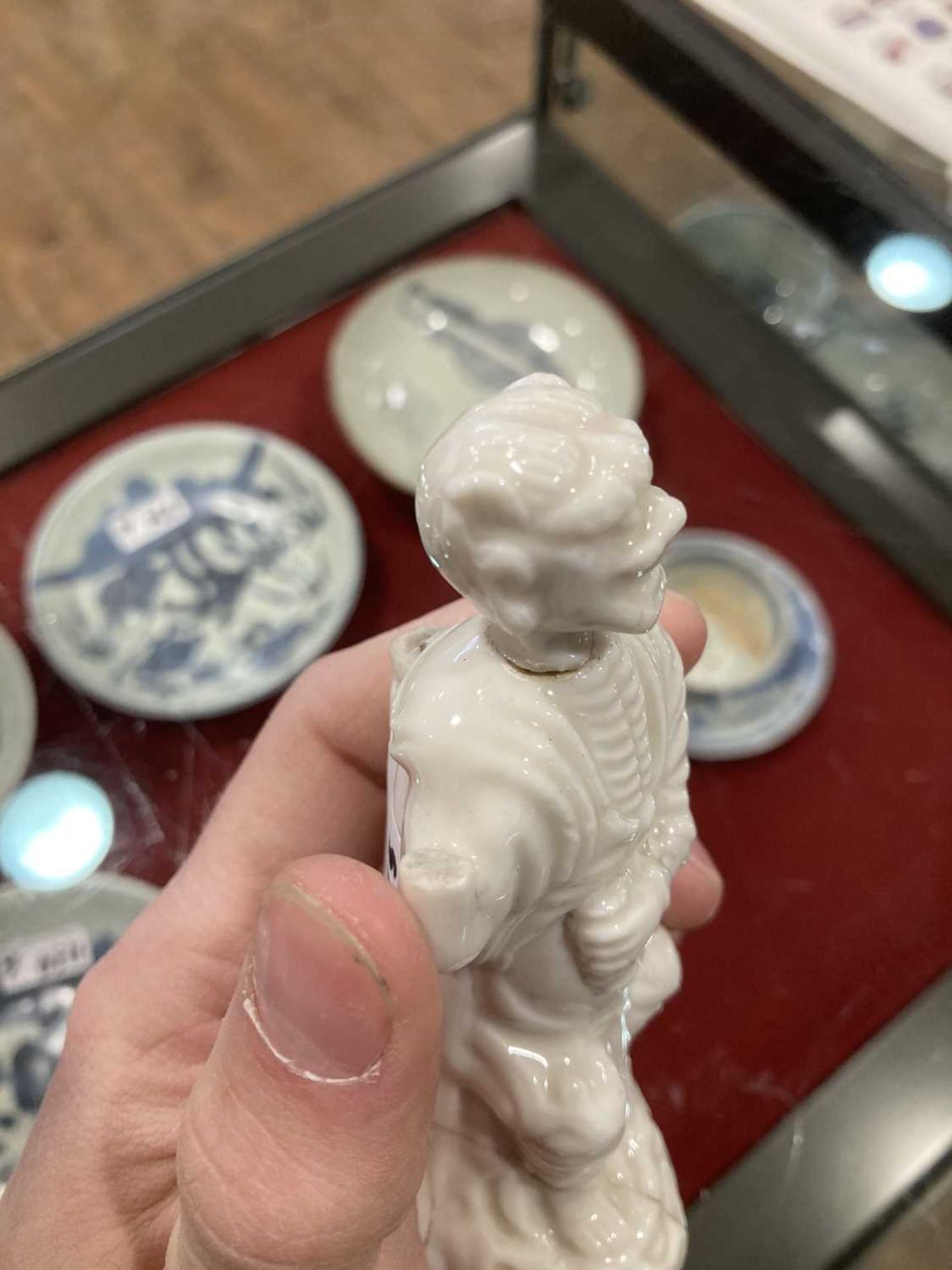 A Chinese blanc de chine figure, possibly Dong Fangshuo, holding a walking stick on a swirl design - Image 19 of 22