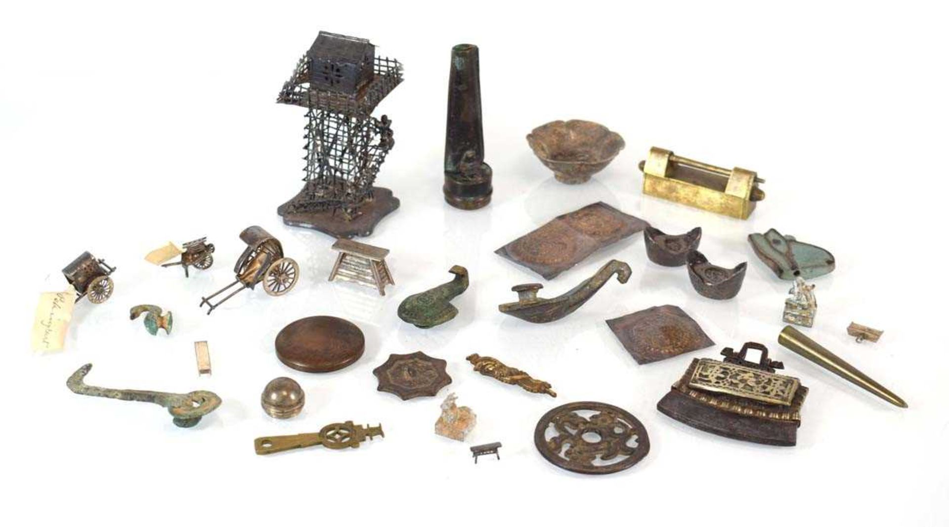 A mixed group of Oriental metalware including a tower, h. 9.5 cm, a wheelbarrow, a rickshaw, pins, a
