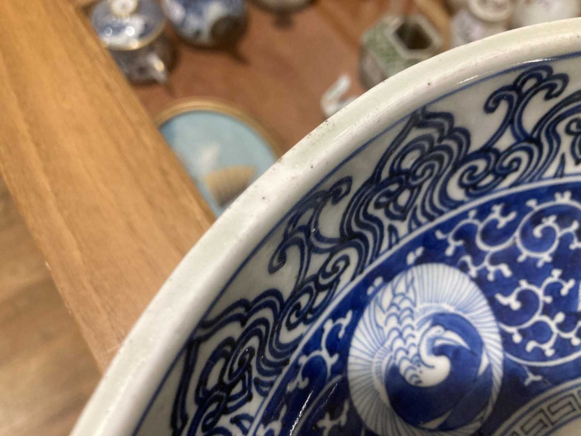 A Japanese blue and white bowl, centrally decorated with a shrubs within a scrolled border, - Image 11 of 12