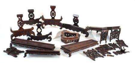 A group of Chinese carved hardwood stands and rests (12) *from the collection of Phillip Allen (