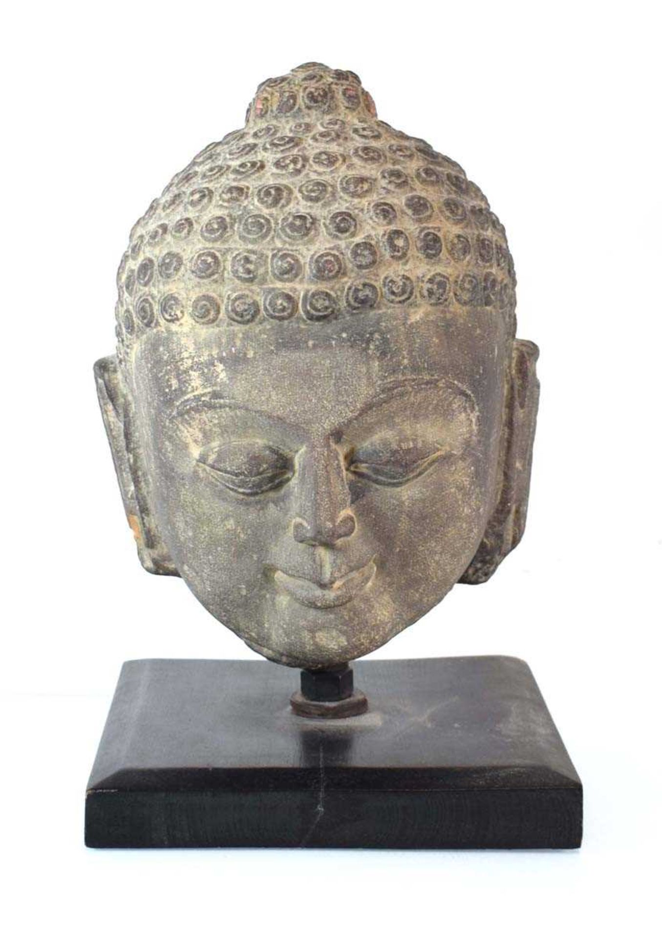 A stoneware figure modelled as the Buddhas head, h. 38.5 cm, including stand *from the collection of