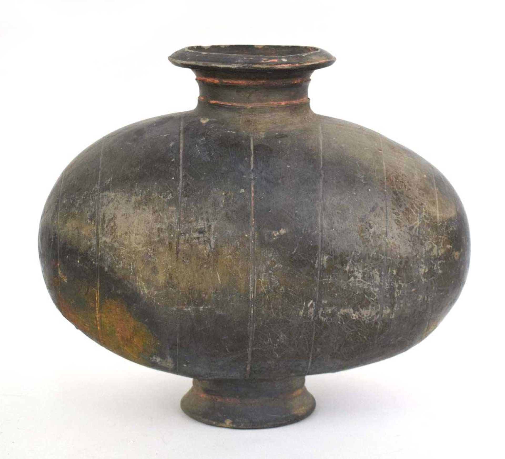 A Chinese pottery cocoon vase, the ovoid body incised with vertical geometric bands, probably Han
