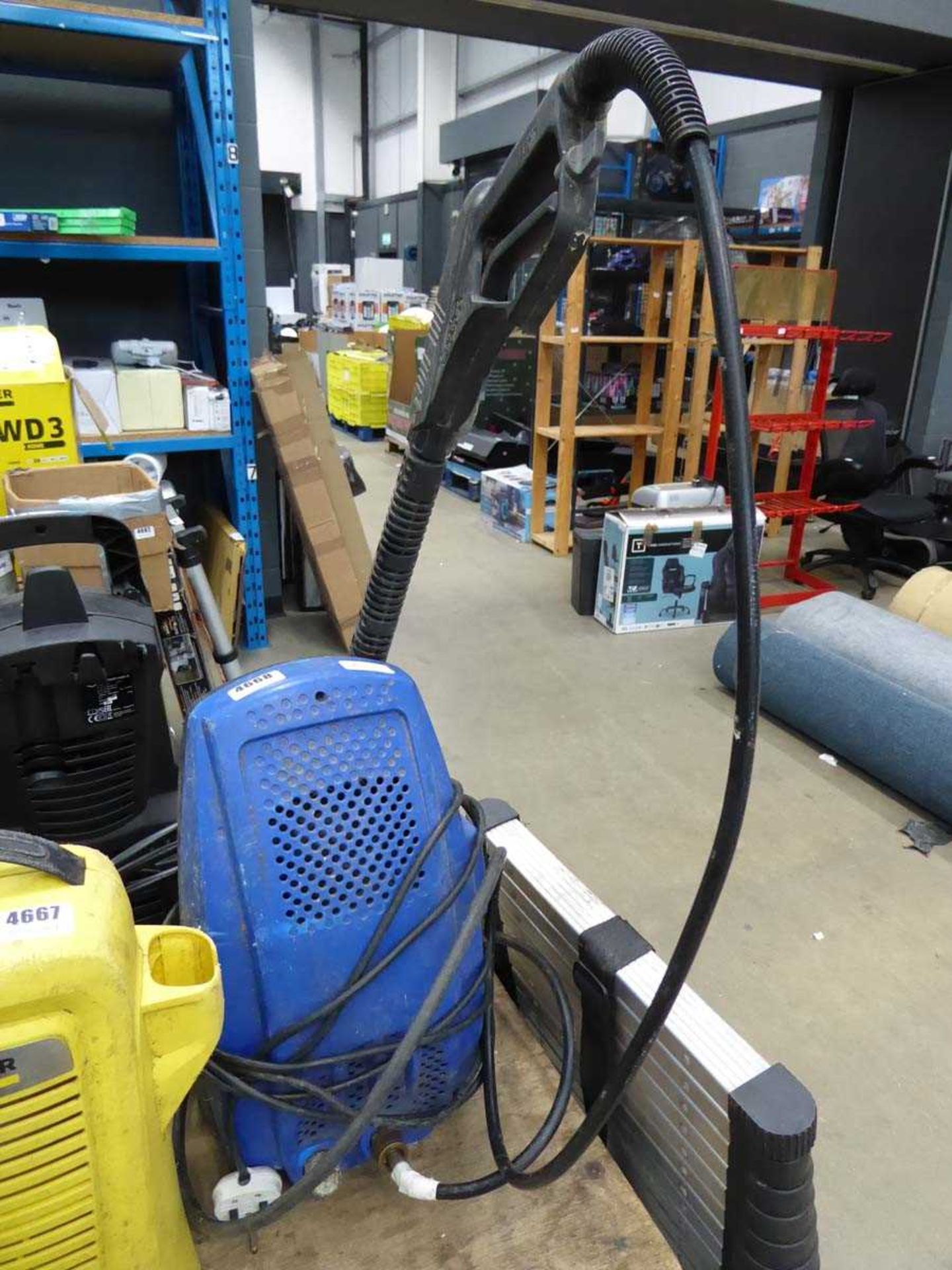 Small blue electric pressure washer with hose and lance